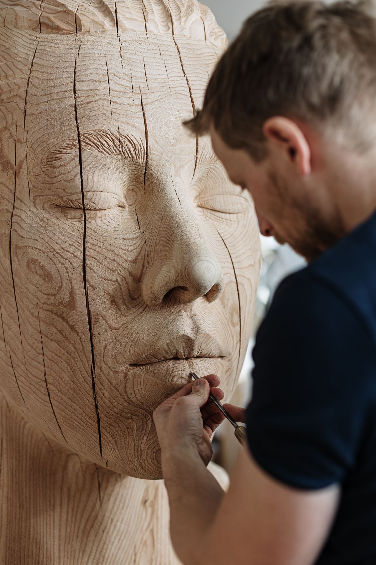 Sculptor working on a large face